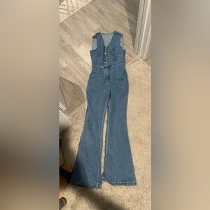 Jean sleeveless jumpsuit size Large. Zipper and buttons in front.